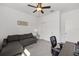 Bright bedroom featuring a ceiling fan, sofa, closet, desk and carpeted floors at 6342 Sw 77Th Ave, Ocala, FL 34474