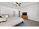 Spacious bedroom featuring tray ceiling, ceiling fan, and large windows for natural light at 6342 Sw 77Th Ave, Ocala, FL 34474