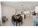 Cozy dining area with a wood table, upholstered chairs, flowing from kitchen and living area at 6342 Sw 77Th Ave, Ocala, FL 34474