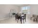 Cozy dining area with a wood table, upholstered chairs, and a window offering natural light at 6342 Sw 77Th Ave, Ocala, FL 34474