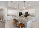 Modern kitchen with white cabinets, stainless steel appliances, granite countertops, and an island with barstool seating at 6342 Sw 77Th Ave, Ocala, FL 34474