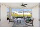 Cozy screened patio with comfortable seating, ceiling fan, and a view of the well-maintained backyard at 6342 Sw 77Th Ave, Ocala, FL 34474
