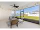 Screened-in patio featuring a ceiling fan, string lights, and comfortable seating area, perfect for outdoor relaxation at 6342 Sw 77Th Ave, Ocala, FL 34474