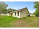 A grassy backyard featuring trees and property line landscaping at 6600 Sw 109Th Ln, Ocala, FL 34476