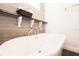 Luxurious soaking tub with elegant fixtures and stylish tile surround at 6600 Sw 109Th Ln, Ocala, FL 34476