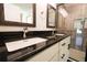 Modern bathroom featuring dual sinks, granite countertops, and a glass-enclosed shower at 6600 Sw 109Th Ln, Ocala, FL 34476
