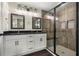 Bathroom boasts a double vanity, wood-look accent wall, and glass-enclosed shower at 6600 Sw 109Th Ln, Ocala, FL 34476