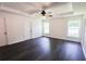 Spacious bedroom with tray ceiling, fan, and hardwood floors at 6600 Sw 109Th Ln, Ocala, FL 34476