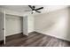 Bright bedroom with wood-look floors, ceiling fan, and walk-in closet at 6600 Sw 109Th Ln, Ocala, FL 34476