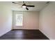 Bright bedroom with natural light, dark vinyl flooring, and modern ceiling fan at 6600 Sw 109Th Ln, Ocala, FL 34476