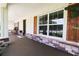 Spacious front porch with a welcome mat, potted plants, and attractive stained wood shutters at 6600 Sw 109Th Ln, Ocala, FL 34476