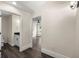Hallway with dark hardwood flooring leading to a bathroom and bedroom with a view to the backyard at 6600 Sw 109Th Ln, Ocala, FL 34476