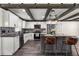 Bright kitchen boasts white cabinets, a center island with seating, and modern stainless steel appliances at 6600 Sw 109Th Ln, Ocala, FL 34476