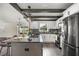 Kitchen with a modern island, decorative backsplash, stainless steel appliances, and wood floors at 6600 Sw 109Th Ln, Ocala, FL 34476