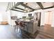 Bright kitchen boasts white cabinets, a center island with seating, and modern stainless steel appliances at 6600 Sw 109Th Ln, Ocala, FL 34476