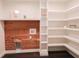 Updated laundry room features wood accent wall, ample shelving and utility connections at 6600 Sw 109Th Ln, Ocala, FL 34476