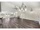 Bright open-concept living room with high ceilings, decorative lighting, and modern vinyl flooring at 6600 Sw 109Th Ln, Ocala, FL 34476