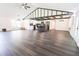 Spacious living room with wood floors, vaulted ceilings, and an open floor plan to the kitchen at 6600 Sw 109Th Ln, Ocala, FL 34476