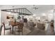 Bright open-concept living room with modern finishes, wood beams and an adjacent island kitchen at 6600 Sw 109Th Ln, Ocala, FL 34476