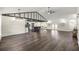 Open concept living room and kitchen with island, updated flooring, high ceilings, and modern lighting at 6600 Sw 109Th Ln, Ocala, FL 34476