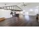 Bright, open-concept living area with dark floors, exposed beams, and a modern kitchen at 6600 Sw 109Th Ln, Ocala, FL 34476