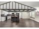 Bright, open-concept kitchen featuring dark floors, exposed beams, and a large kitchen island at 6600 Sw 109Th Ln, Ocala, FL 34476