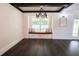 Living room featuring a window seat, wood floors, chandelier, and modern lighting at 6600 Sw 109Th Ln, Ocala, FL 34476