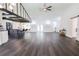 Bright, open-concept living area with dark floors, exposed beams, and a stylish kitchen island at 6600 Sw 109Th Ln, Ocala, FL 34476