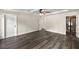 Main bedroom with hardwood floors, ceiling fan, and doors to the bathroom and bedroom at 6600 Sw 109Th Ln, Ocala, FL 34476