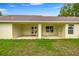 An open patio featuring ceiling fans, sturdy support beams, and a serene view of the backyard at 6600 Sw 109Th Ln, Ocala, FL 34476