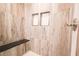 Modern shower with wood-style tile and a built-in bench at 6600 Sw 109Th Ln, Ocala, FL 34476
