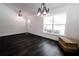 Bright sitting area with a large window, door to exterior, and stylish light fixture at 6600 Sw 109Th Ln, Ocala, FL 34476