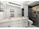 Bright bathroom featuring a double sink vanity and glass-enclosed shower at 6758 Sw 114Th Street Rd, Ocala, FL 34476