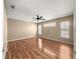 Spacious bedroom with a ceiling fan, wood floors, and two windows, offering natural light at 6758 Sw 114Th Street Rd, Ocala, FL 34476