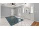 Bright entryway with tile flooring, a tray ceiling, and a view into the living room at 6758 Sw 114Th Street Rd, Ocala, FL 34476