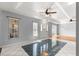 Welcoming entryway with tile flooring, a tray ceiling, and views into a spacious living area at 6758 Sw 114Th Street Rd, Ocala, FL 34476