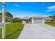 Charming single Gathering home with a two-car garage and well-manicured front lawn on a beautiful, sunny day at 6758 Sw 114Th Street Rd, Ocala, FL 34476