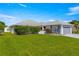 Beautifully landscaped lawn compliments the single Gathering home with attached two car garage on a sunny day at 6758 Sw 114Th Street Rd, Ocala, FL 34476