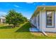 Exterior side view of a single Gathering home with a manicured lawn, trees, and well maintained exterior at 6758 Sw 114Th Street Rd, Ocala, FL 34476