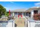 Back of house featuring a red front door, small patio, and a table with chairs at 6758 Sw 114Th Street Rd, Ocala, FL 34476