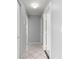 Neutral colored hallway with stylish tile flooring and lighting at 6758 Sw 114Th Street Rd, Ocala, FL 34476