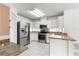 Bright kitchen features stainless steel appliances, granite countertops, white cabinets and tiled backsplash at 6758 Sw 114Th Street Rd, Ocala, FL 34476