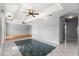 Spacious living room with a green tile accent, hardwood floors, and a tray ceiling at 6758 Sw 114Th Street Rd, Ocala, FL 34476