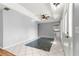 Open-concept living room with stylish tile flooring, modern fan, and recessed lighting, freshly painted in neutral grey at 6758 Sw 114Th Street Rd, Ocala, FL 34476