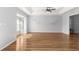 Sunlit living room with modern floating shelves, hardwood flooring, and recessed lighting at 6758 Sw 114Th Street Rd, Ocala, FL 34476