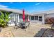 Cozy backyard patio area, perfect for outdoor dining with a table and umbrella at 6758 Sw 114Th Street Rd, Ocala, FL 34476