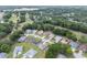Aerial view of a residential area with lush greenery, mature trees and well-manicured lawns at 6858 Sw 111Th Loop, Ocala, FL 34476