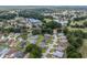 Aerial view of the community with mature trees, manicured lawns, pond, and community center at 6858 Sw 111Th Loop, Ocala, FL 34476