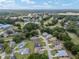 An aerial view of a residential neighborhood with mature trees, golf course and community pond at 6858 Sw 111Th Loop, Ocala, FL 34476