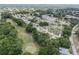 An aerial view showing the community layout, mature trees and a nearby golf course at 6858 Sw 111Th Loop, Ocala, FL 34476